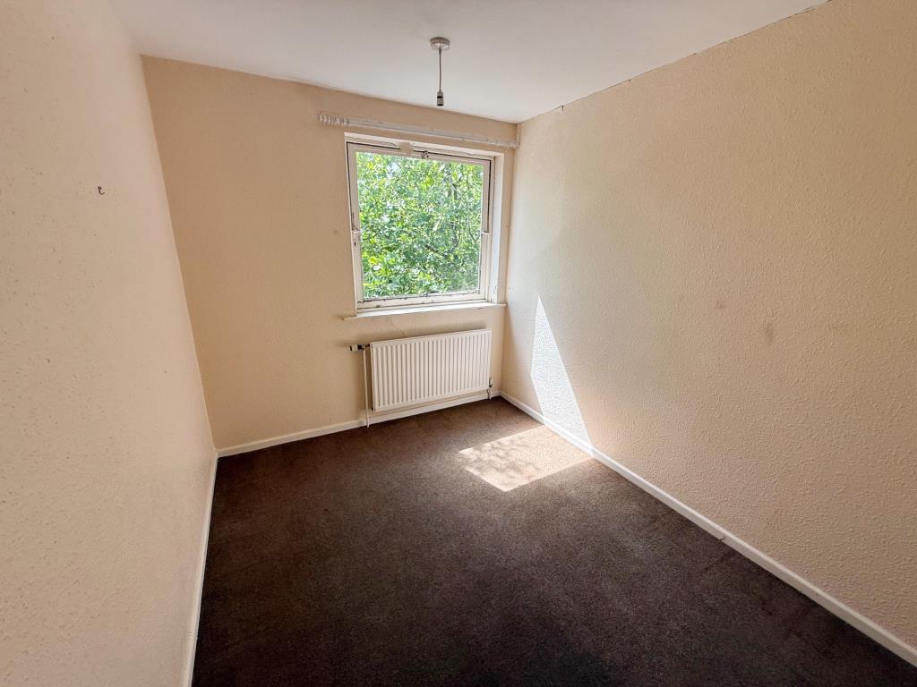 Lot: 1 - FIRST AND SECOND FLOOR THREE-BEDROOM MAISONETTE - Bedroom 3 with painted walls and dark carpet
